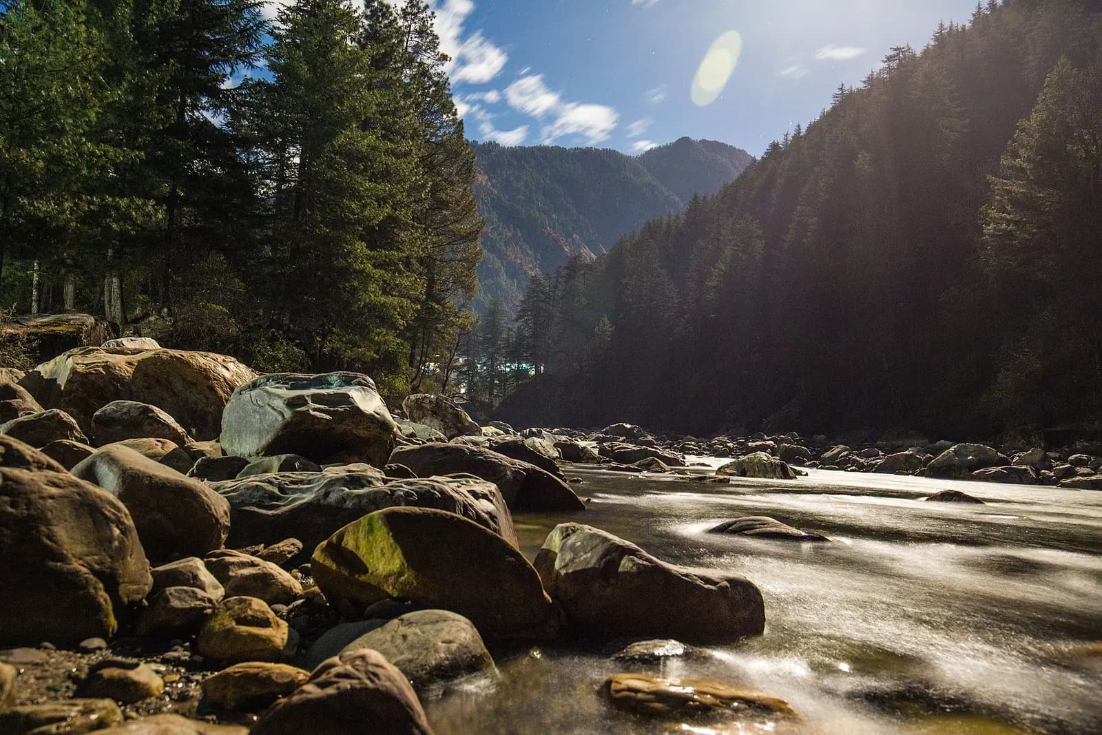 The Parvati river running fast over pale boulders in Himachal Pradesh
