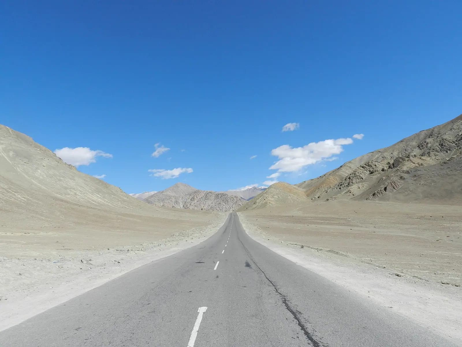 The empty highway running through barren hills near Magnetic Hill in Ladakh