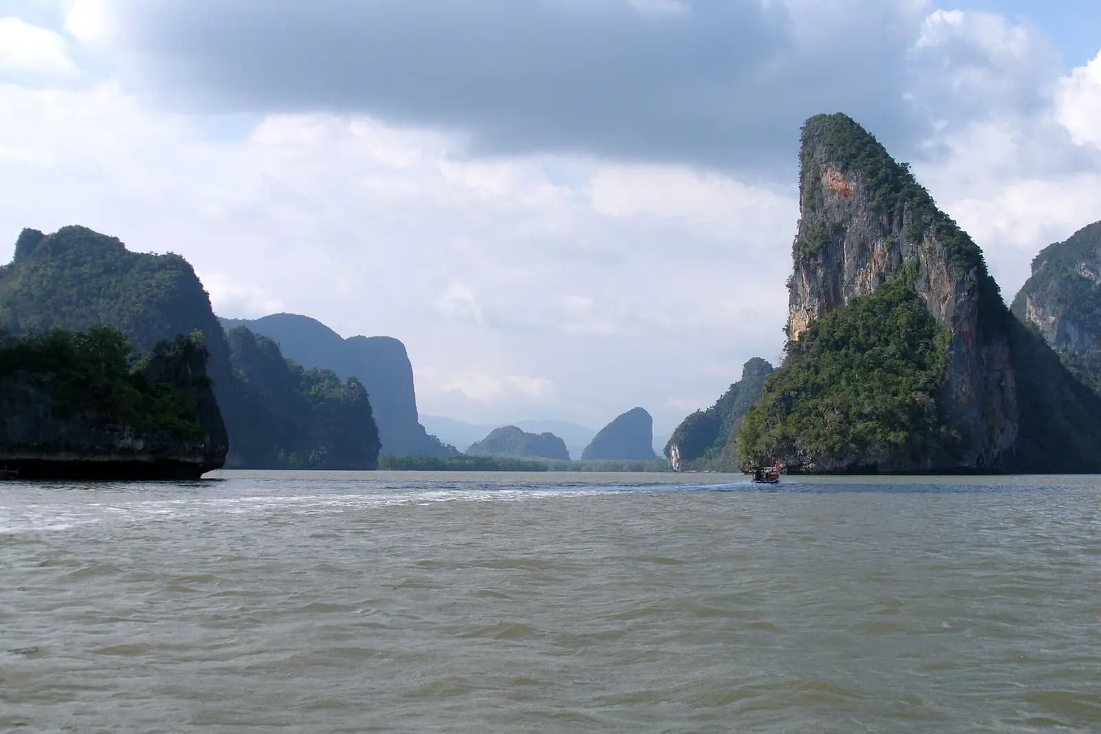 Limestone karst islands standing in calm sea in southern Thailand