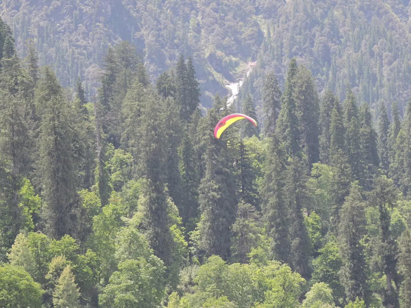 Paragliding and ropeway activity above Solang Valley near Manali, Himachal Pradesh