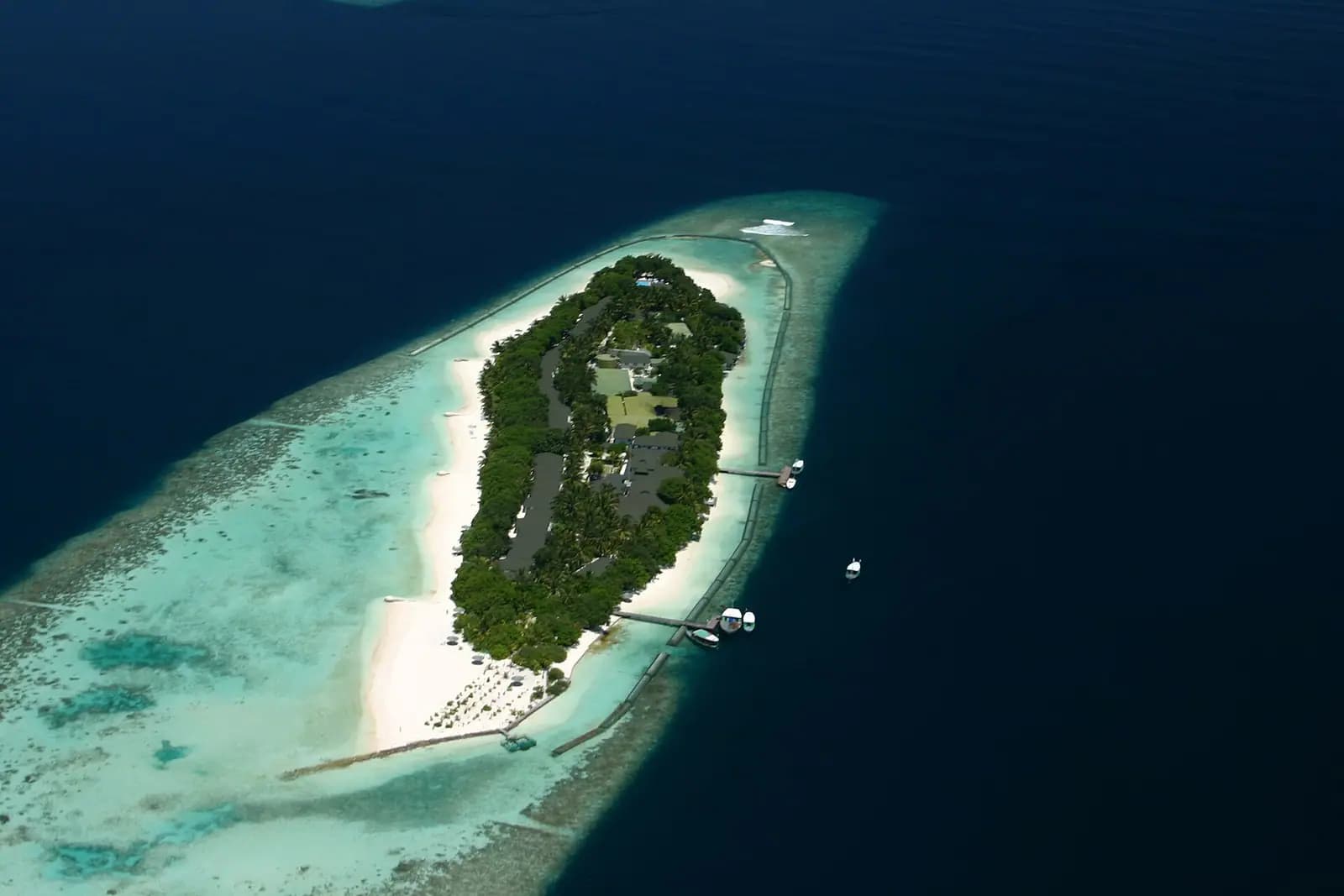 A small resort island ringed by sandbank and reef in the Maldives