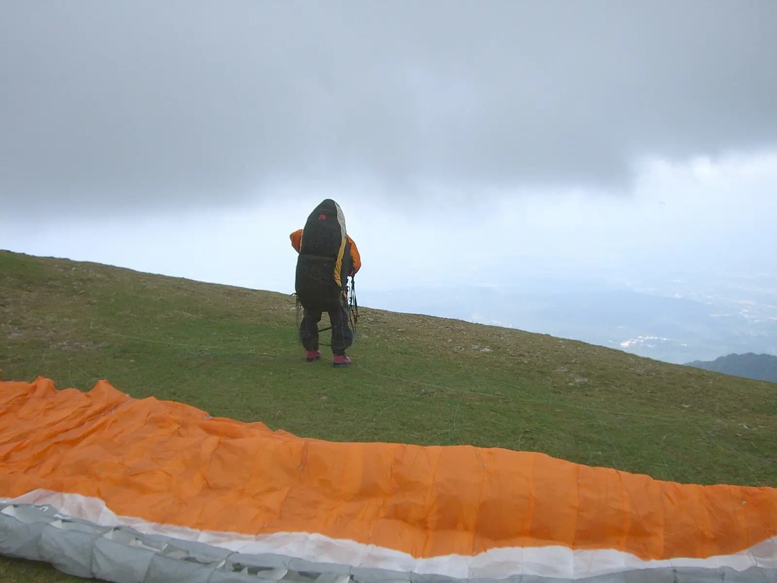 Paragliders above the landing meadow at Bir in the Kangra valley, Himachal Pradesh