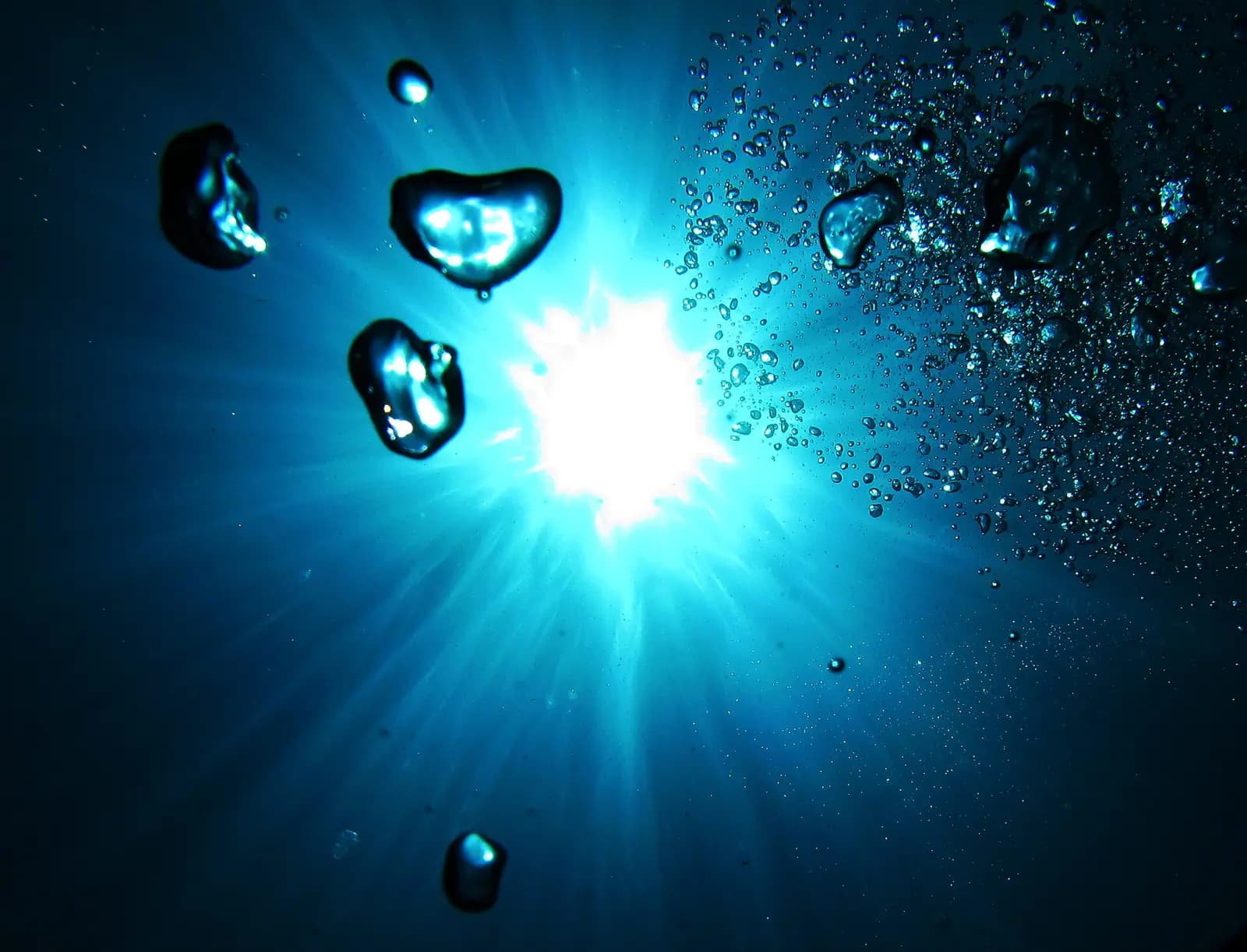 Sunlight through the surface above a diver in the Andaman Islands