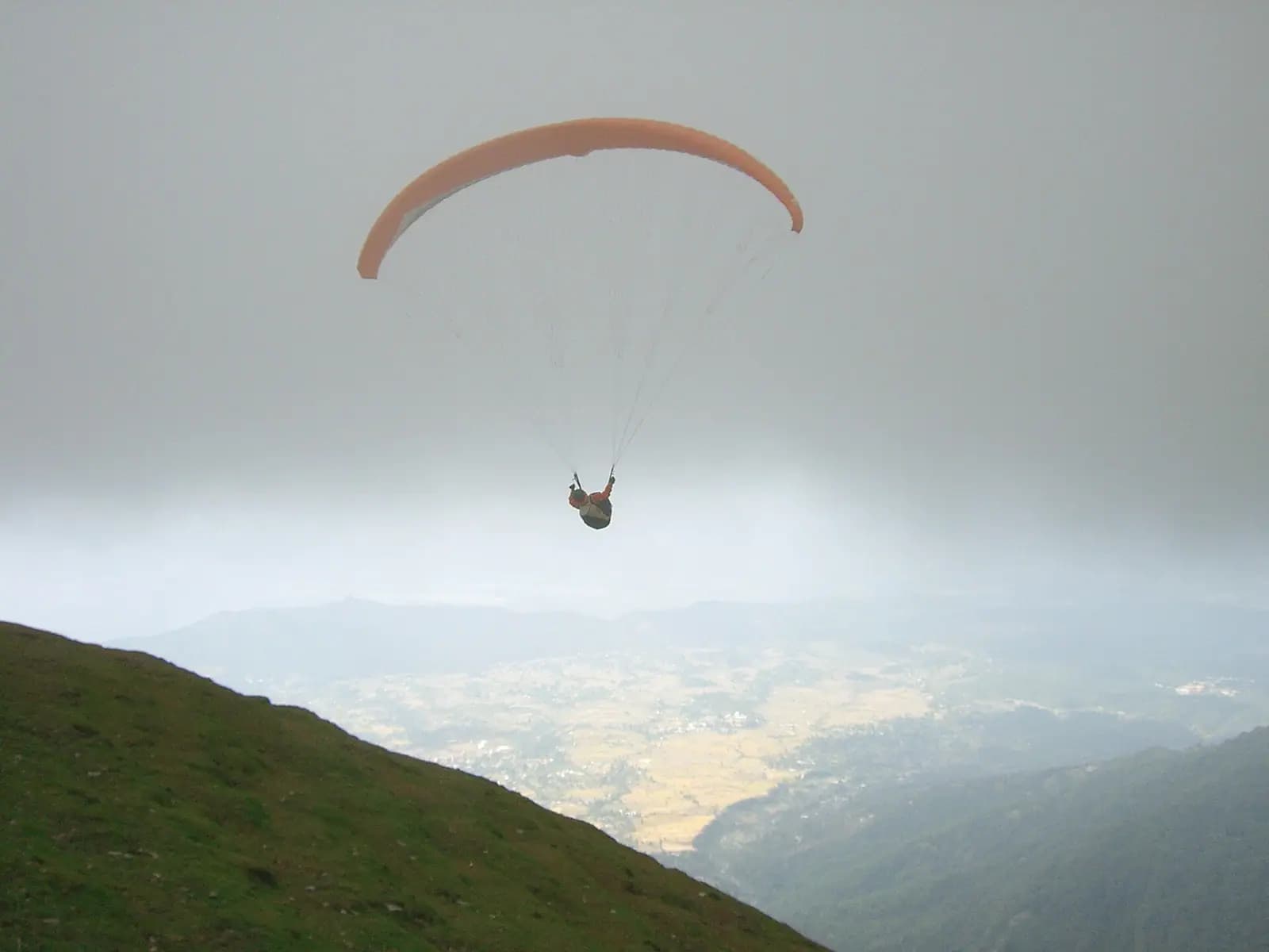 A paraglider above the Kangra valley at Bir Billing, Himachal Pradesh