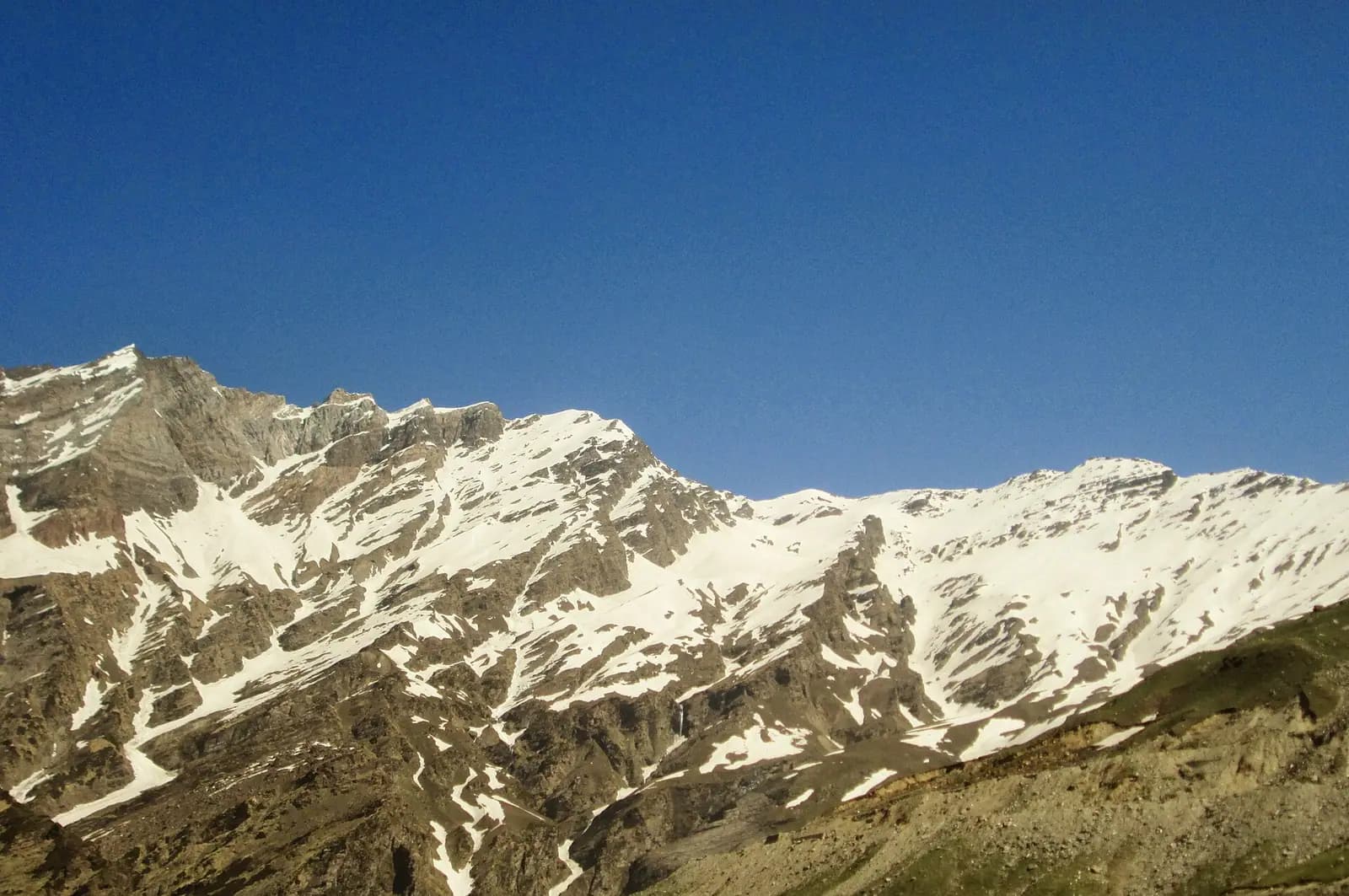 Snow-covered Himalayan peaks above a valley in Himachal Pradesh